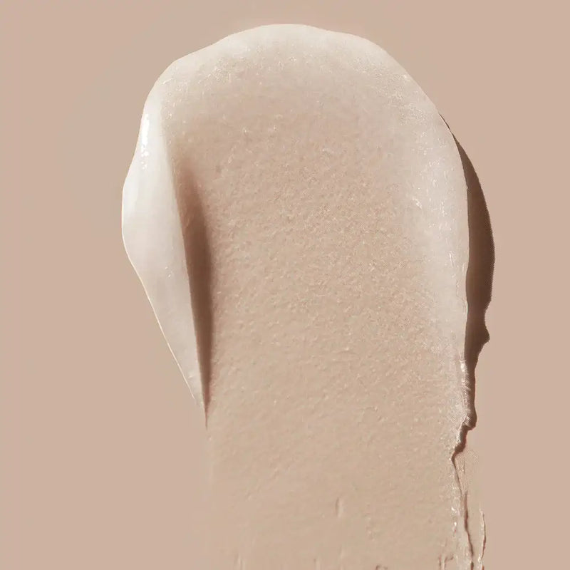 Creamy swatch of LIPSMART Hydrating Lip Treatment on a beige background, showcasing its smooth texture for hydrated lips.