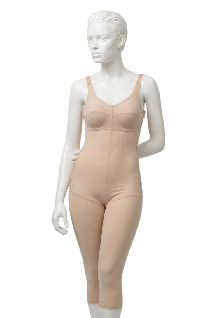 Beige full-body compression garment on mannequin for recovery support