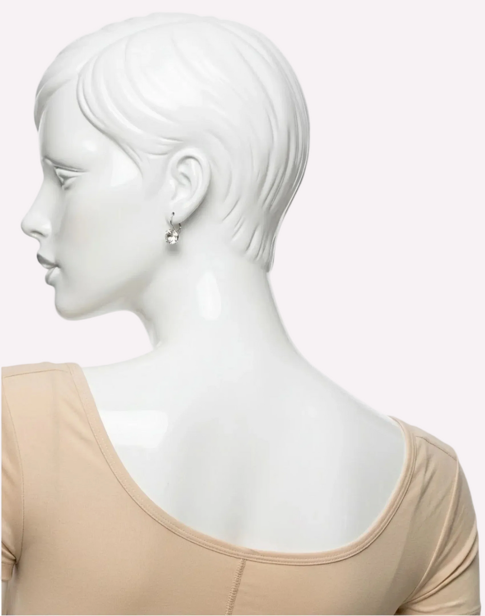 Back view of mannequin wearing beige short-sleeve compression top for recovery