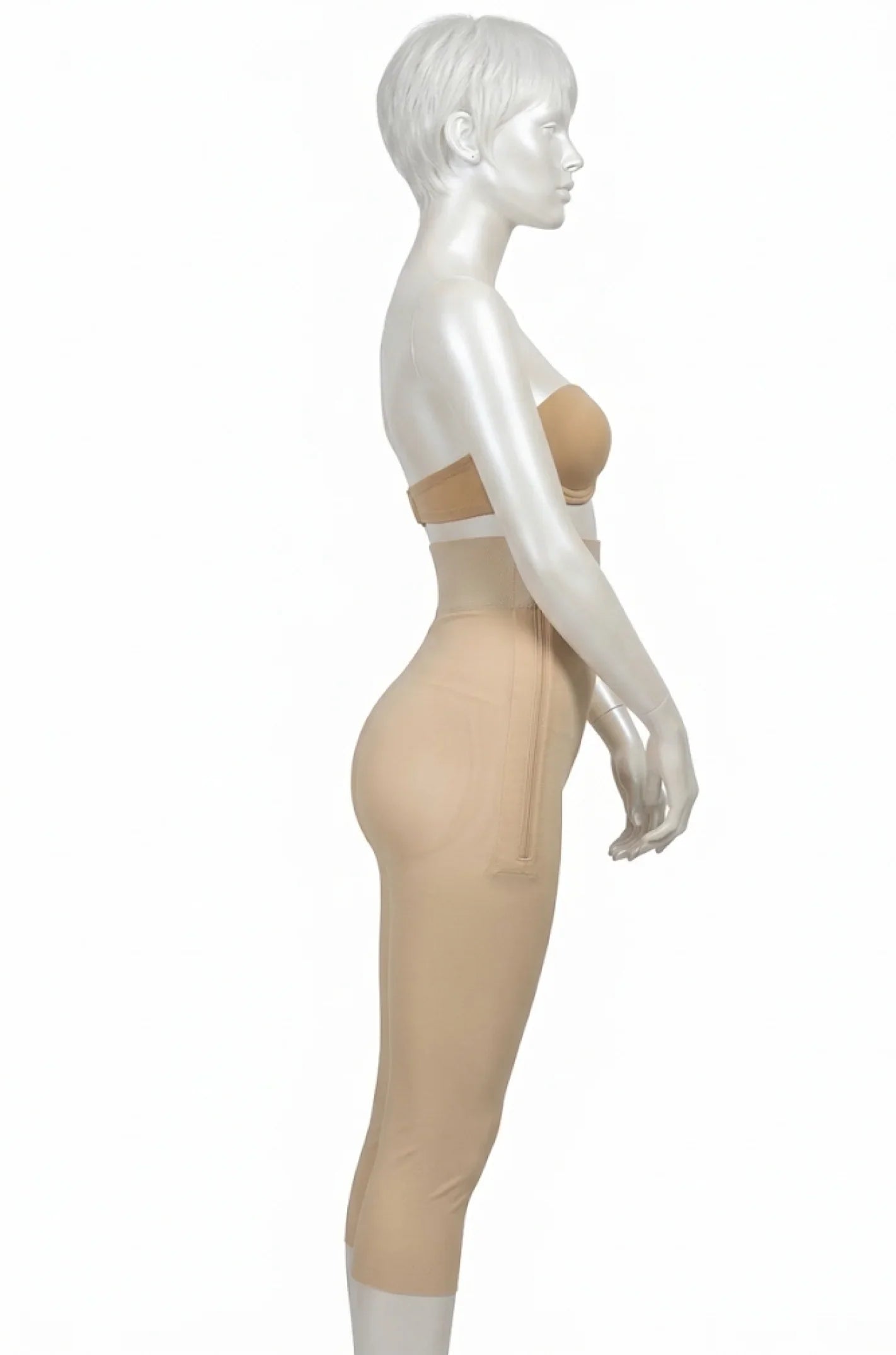 Side view of mannequin wearing beige high-waist compression garment for recovery