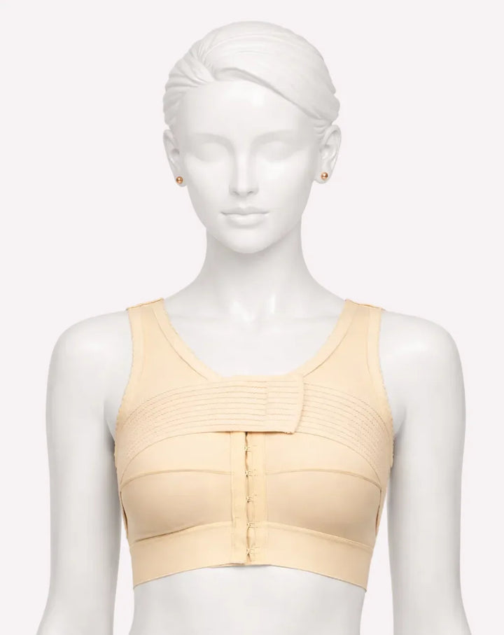Mannequin wearing a beige compression bra on a white background