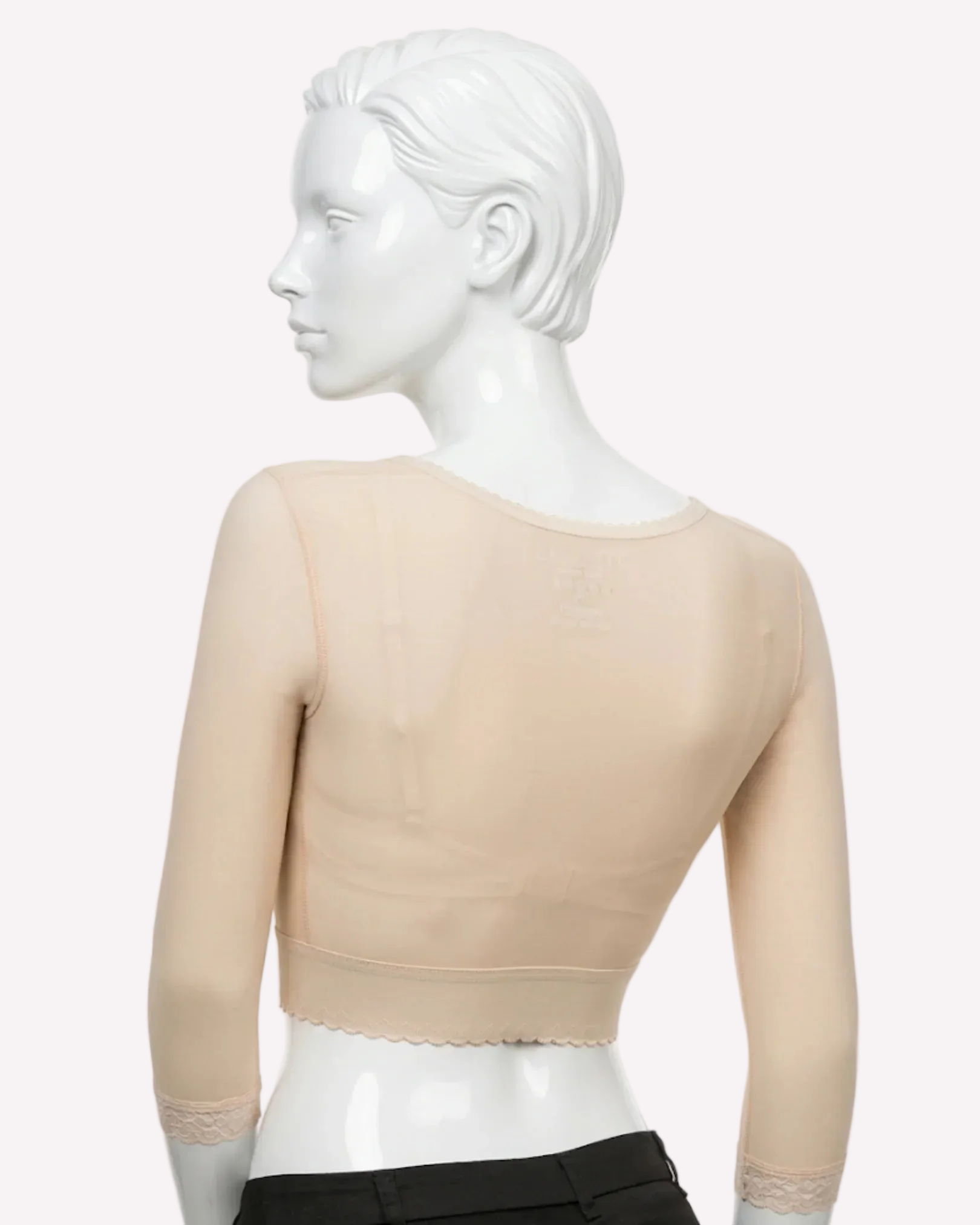 Beige long sleeve compression bolero garment with lace trim on mannequin, back view